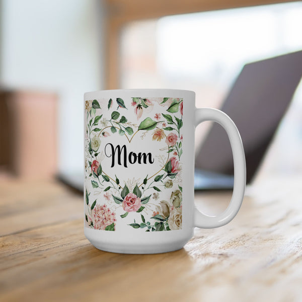White mug with floral design and 'Mom' text on a wooden surface