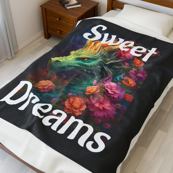 Colorful dragon and floral design on a blanket with 'Sweet Dreams' text, draped over a bed.
