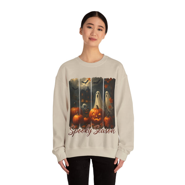 Person wearing a beige sweatshirt with Halloween-themed design featuring pumpkins and ghosts.