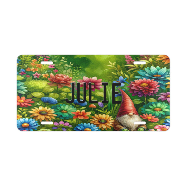 Personalized Gnome Vanity Custom Front License Plate with gnome in a field of flowers n red, blue, teal, and orange. The license plate has your name in black using the same license plate font found on regular state plates.