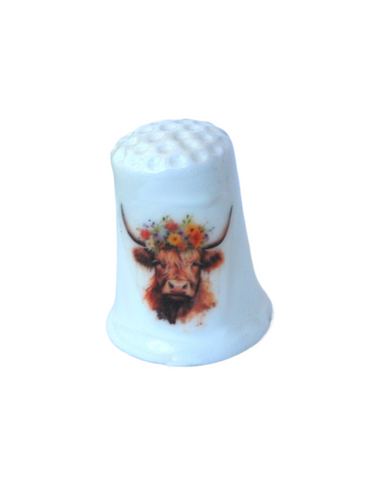 Collectible thimble featuring a highland cow