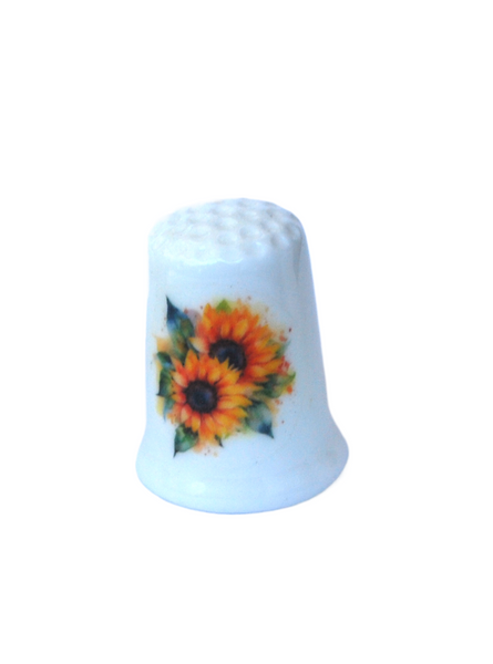 Collectible thimble with sunflowers on it.