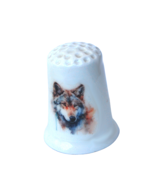 Collectible thimble with a watercolor wolf decal on it.
