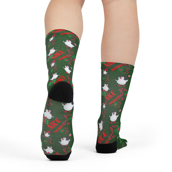 Green socks with Christmas-themed designs on a white background
