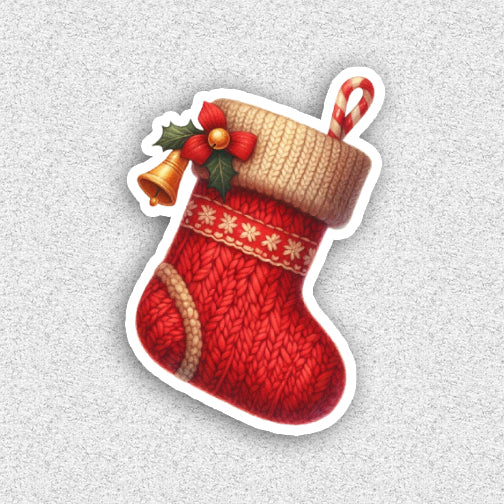 Red Christmas stocking with candy cane and holly on a light gray background