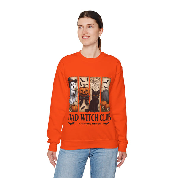 Person wearing an orange sweatshirt with Halloween-themed design and 'Bad Witch Club' text.