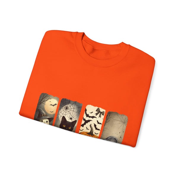Folded orange sweatshirt with Halloween-themed design on a white background