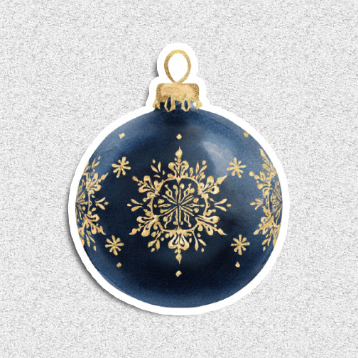 Decorative Christmas ornament with gold snowflake design on a blue background