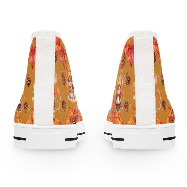 White sneakers with a colorful fall-themed pattern on the back, including pumpkins and leaves.