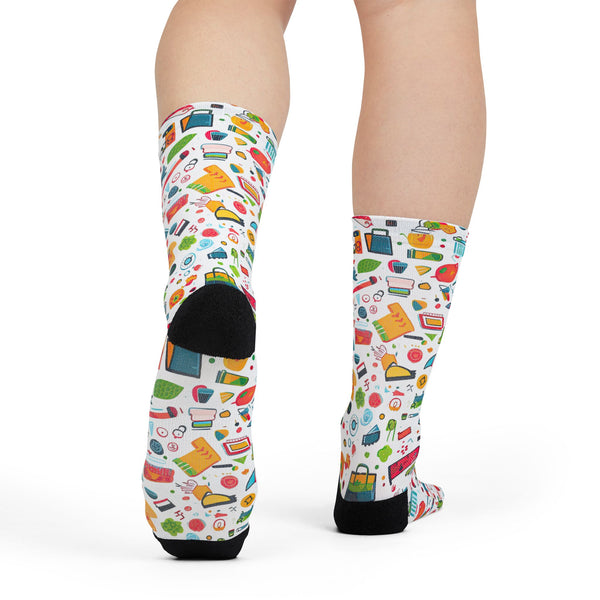 Colorful patterned socks worn by a person on a white background