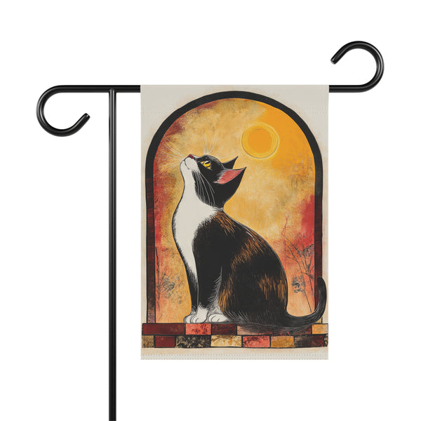Decorative garden flag with a cat design against a sunset background, attached to a flagpole.