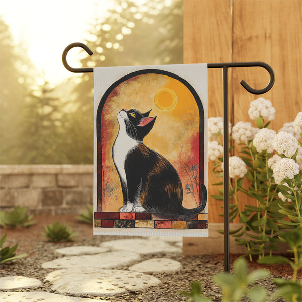 Decorative garden flag with a cat design on a stand outdoors.