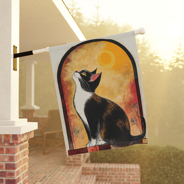 Decorative garden flag with a cat design hanging on a porch.