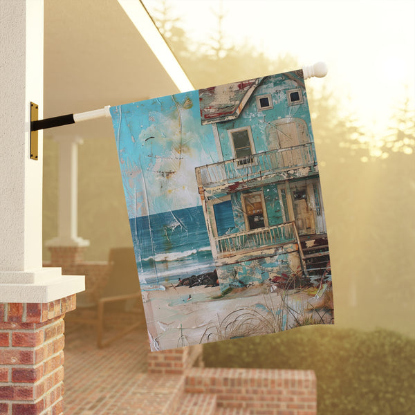 Decorative flag with a house design hanging on a porch