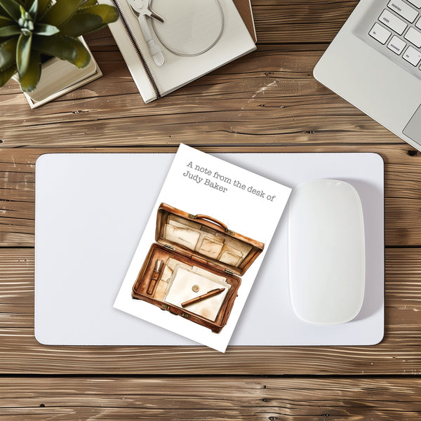 Notebook with a wooden desk illustration on a desk with a laptop, mouse, and plant.