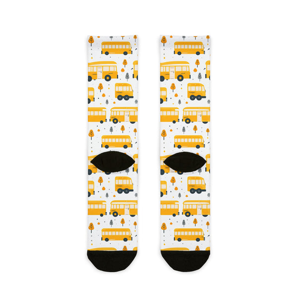 Pair of socks with yellow school bus pattern on a white background