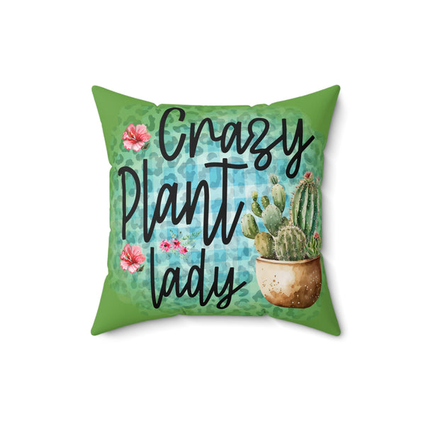 Decorative pillow with 'Crazy Plant Lady' text and cactus design on a green background
