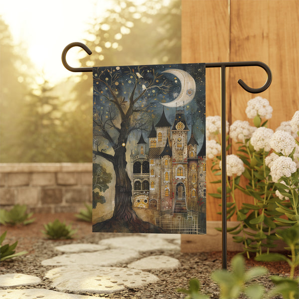 Decorative garden flag with a castle and tree design, hanging outdoors.