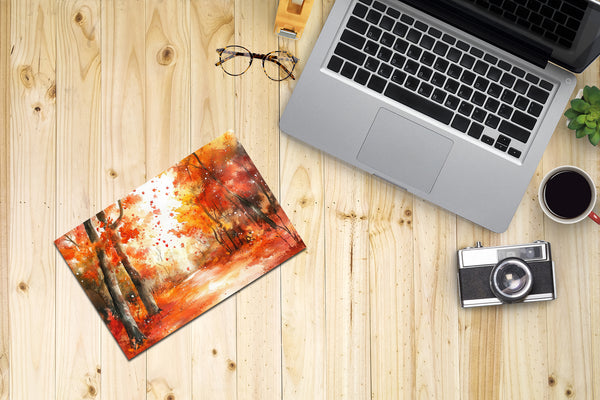 Laptop, painting, camera, and coffee on a wooden surface