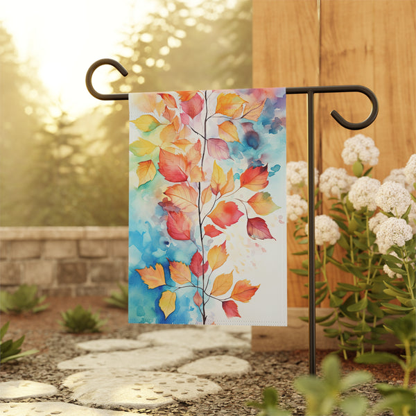 Decorative garden flag with autumn leaf design on a stand outdoors.