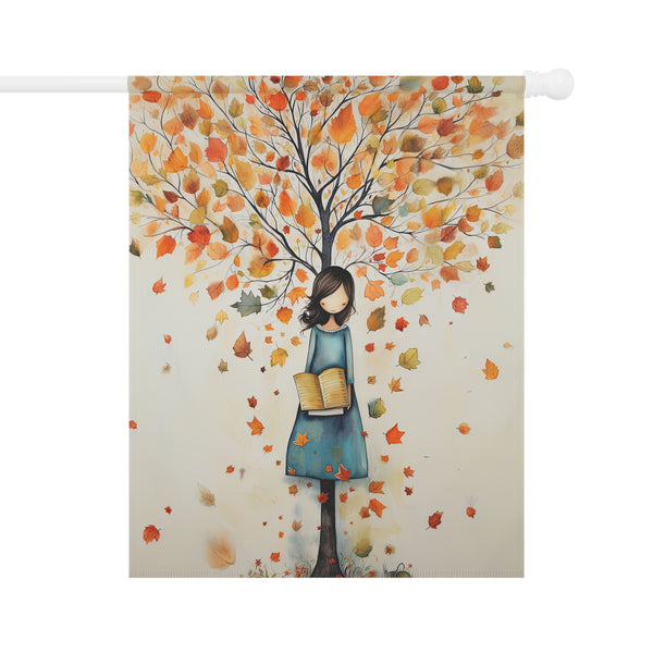 Decorative flag with a woman holding books under an autumn tree