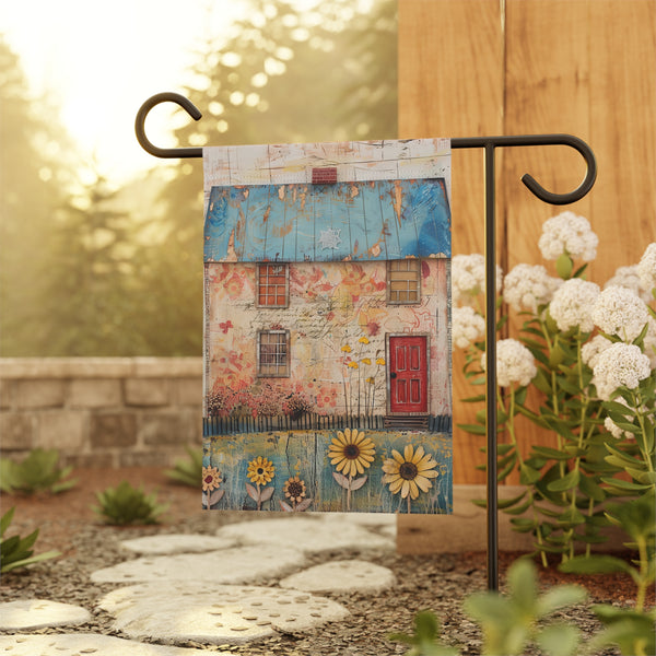 Decorative garden flag with a house design on a stand in a garden setting.