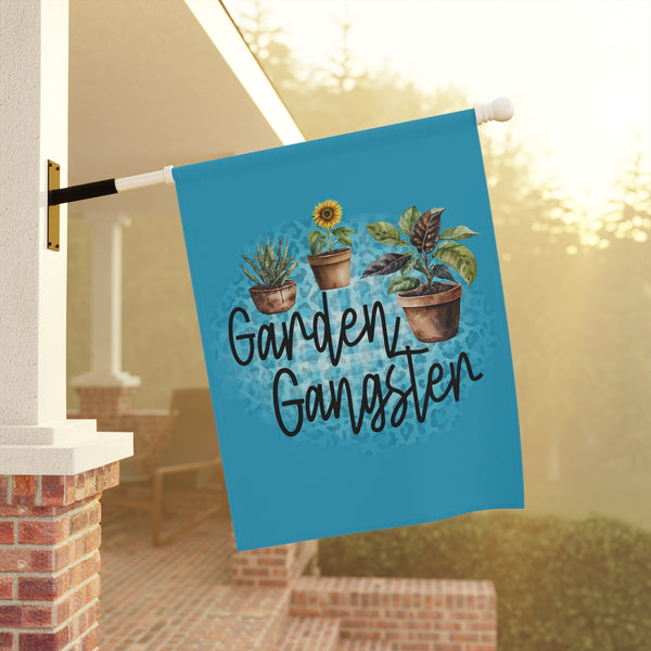 Decorative garden flag with plants and 'Garden Gangster' text on a porch.