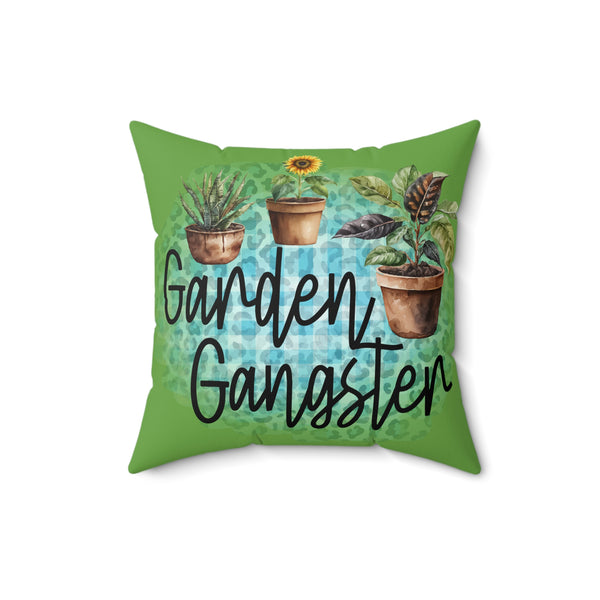 Pillow with 'Garden Gangster' text and plant illustrations on a green background