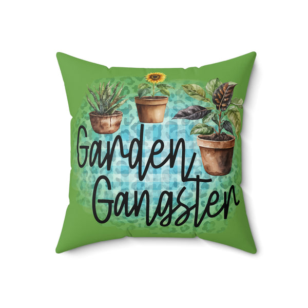 Pillow with 'Garden Gangster' text and plant illustrations on a green background