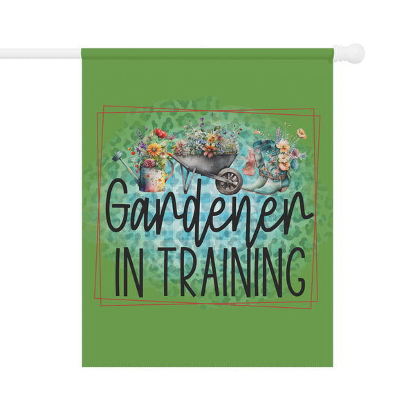 Decorative flag with 'Gardener in Training' text and gardening-themed design on a green background.
