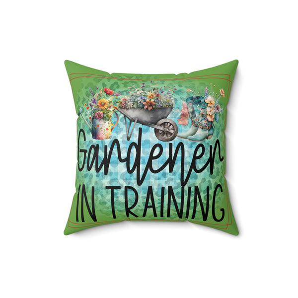 Decorative pillow with 'Gardener in Training' text and gardening-themed design on a white background
