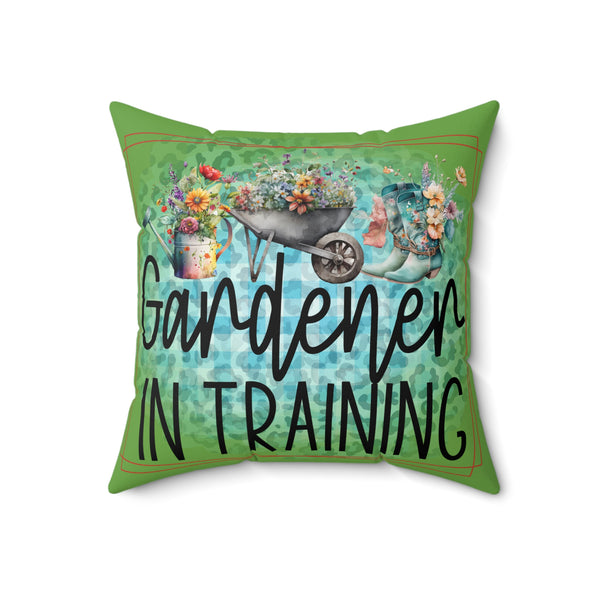 Decorative pillow with 'Gardener in Training' text and gardening-themed graphics on a white background.