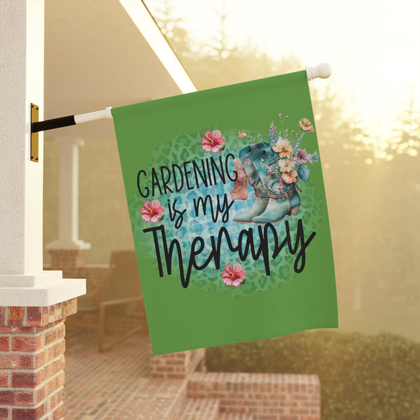 Decorative garden flag with 'Gardening is my Therapy' text and floral design, hanging outdoors.