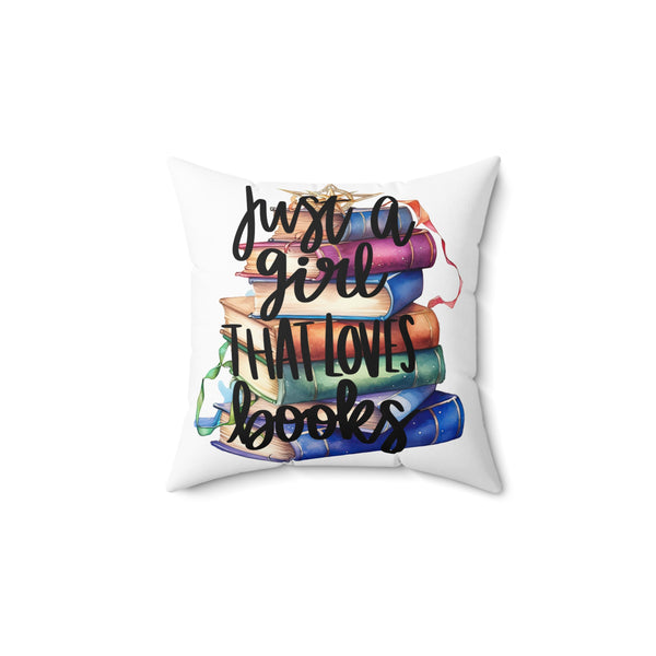 Decorative pillow with books and text 'Just a girl that loves books' on a white background