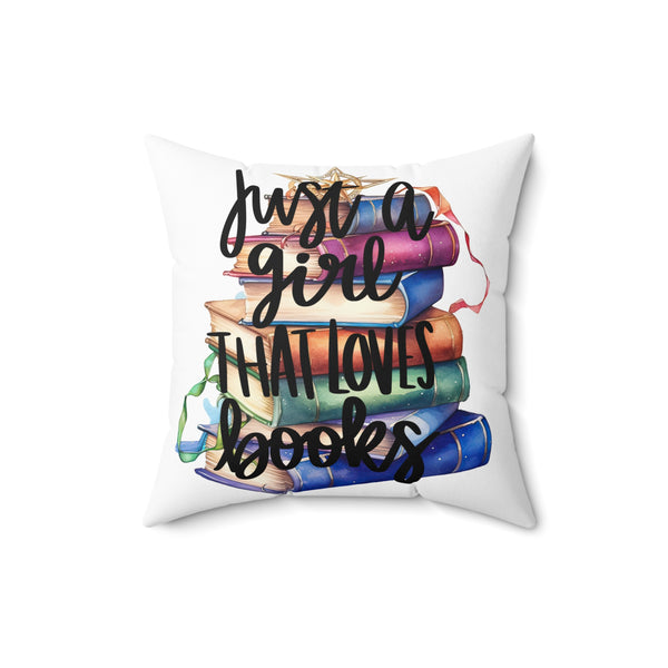 Decorative pillow with colorful books and text 'Just a girl that loves books' on a white background