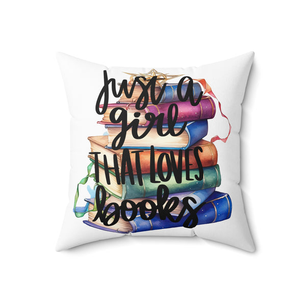 Decorative pillow with colorful books and text 'Just a Girl That Loves Books' on a white background