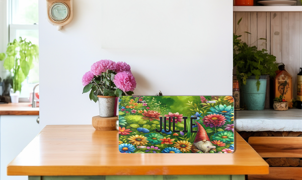 Personalized Gnome Vanity Custom Front License Plate sitting on a table with pink flowers in the background in a ktichen