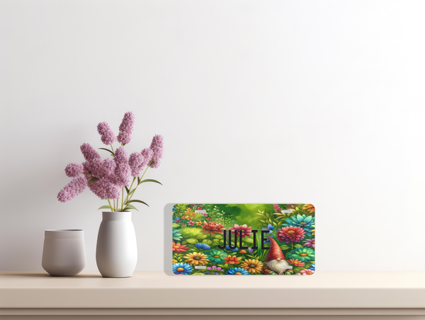 Personalized Gnome Vanity Custom Front License Plate sitting on a shelf with a pink flower