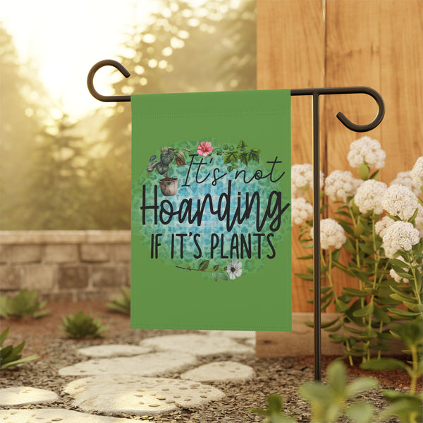 Garden flag with plant-themed text on a stand outdoors
