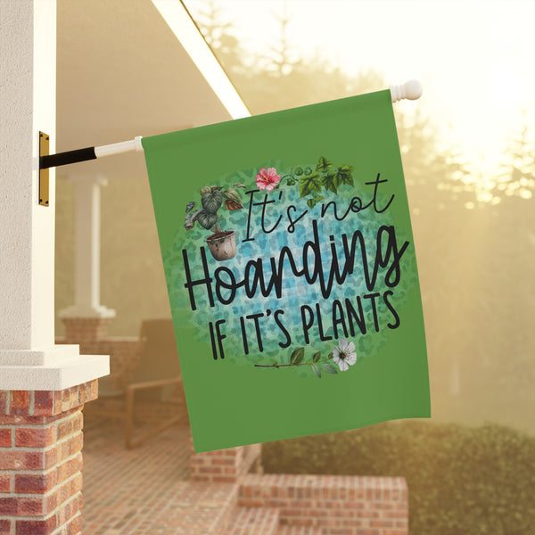 Decorative garden flag with plant-themed text hanging on a porch