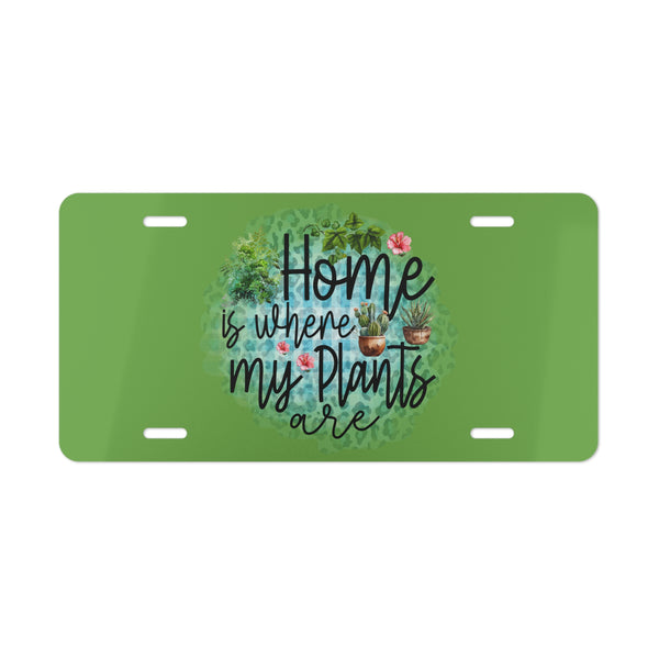 Green license plate with 'Home is where my plants are' text and plant illustrations on a white background