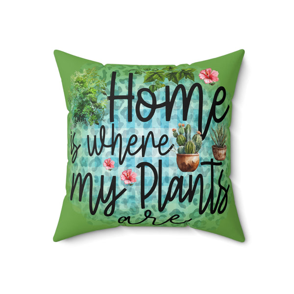 Green pillow with plant-themed text design on a white background
