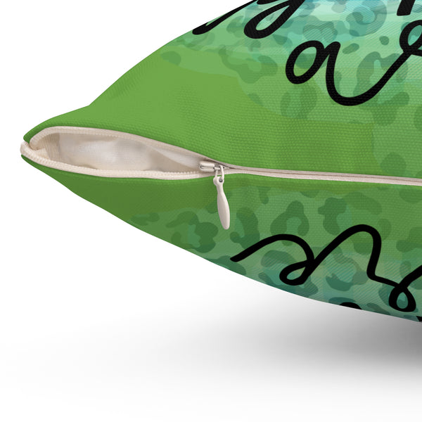 Green pillow with black text on a white background