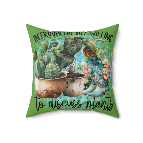 Decorative pillow with plants and text on a green background