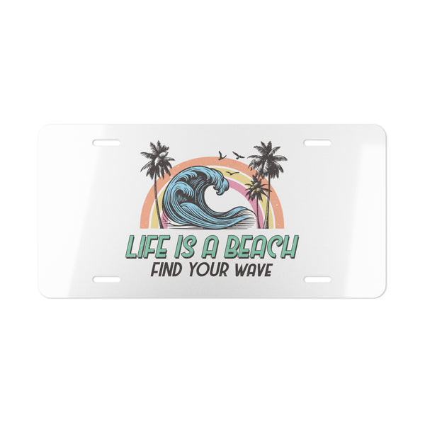 License plate with 'Life is a Beach, Find Your Wave' design featuring a wave, palm trees, and rainbow on a white background.