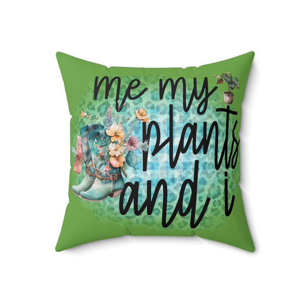 Green pillow with text 'me my plants and i' and floral design on a white background