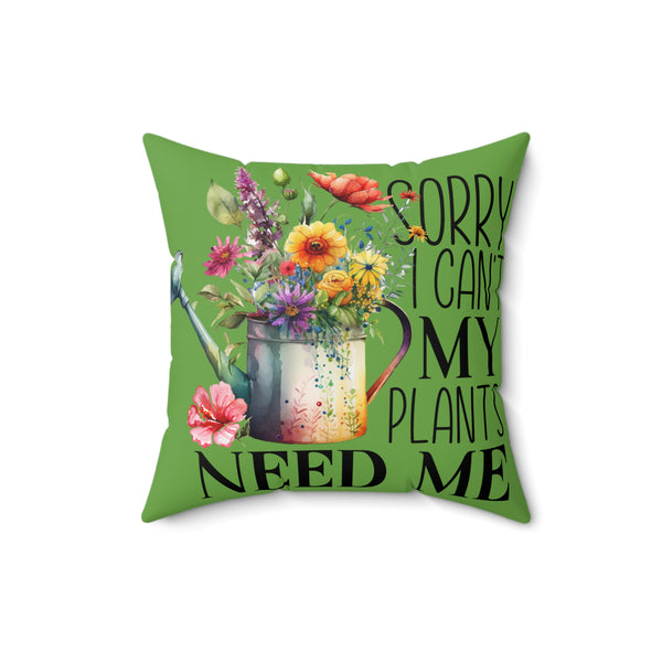 Green pillow with floral design and text 'Sorry I can't my plants need me' on a white background