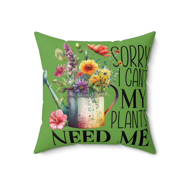 Green pillow with floral design and text 'Sorry can't my plants need me' on a white background