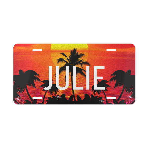 License plate with 'JULIE' and palm tree design against a sunset background