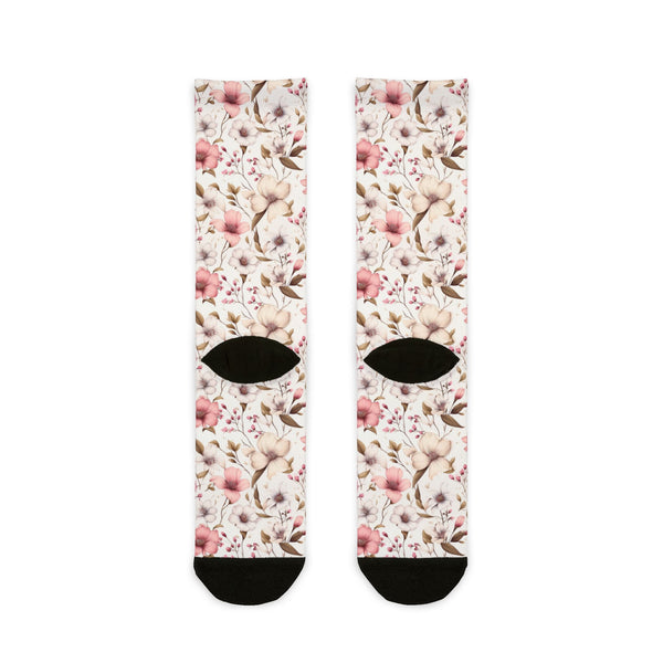 Floral patterned socks with black accents on a white background
